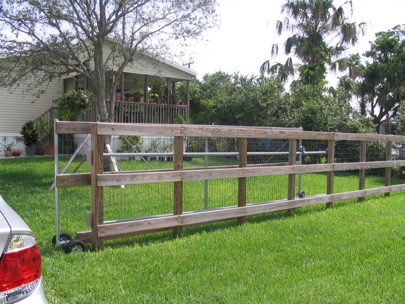 Wood post and rail fence with wire mesh infill installation in Fort Lauderdale for residential yards, pets, property lines, open-view fencing, and wood gates