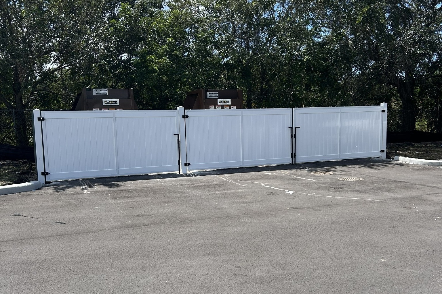 Commercial dumpster fence gate installation by Saylor Fence in Davie and Fort Lauderdale