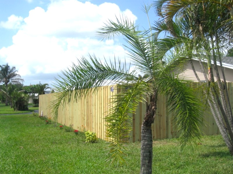 Property line privacy fence installation creating separation between neighboring properties and side or rear boundaries
